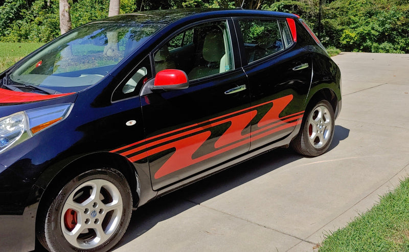 zigzag red vinyl Stripes on black hatchback car